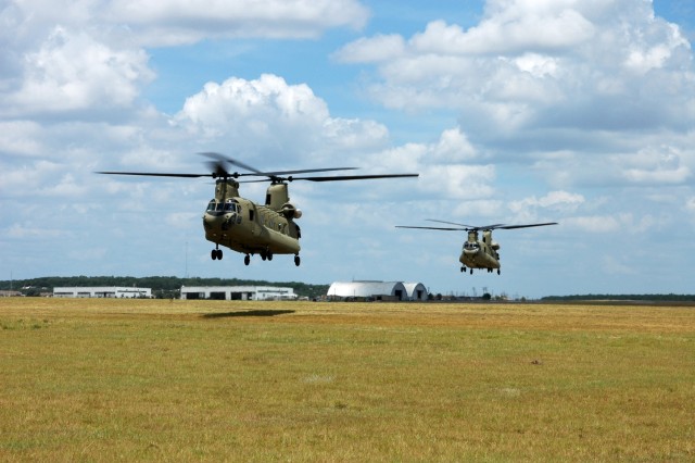 Two new CH-47F Chinook helicopters from Company B, 2nd Battalion, 227th Aviation Regiment, 1st Air Cavalry "Warrior" Brigade, 1st Cavalry Division, hover in a holding pattern before lifting off on a training mission at Fort Hood Army Airfield,...