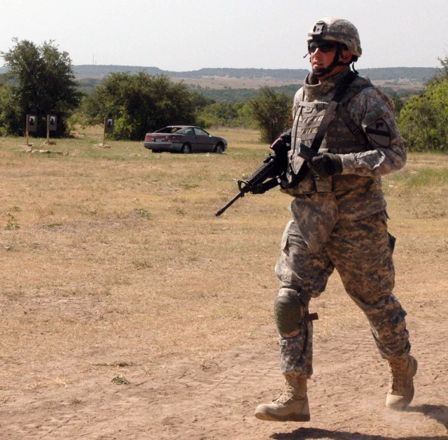 Sgt. 1st Class James Maxwell, with Company A, 3rd Battalion, 8th Cavalry Regiment, 3rd Brigade Combat Team, 1stt Cavalry Division from Manistique, Wis. completes the final leg of an exhausting timed training exercise that included various firing...