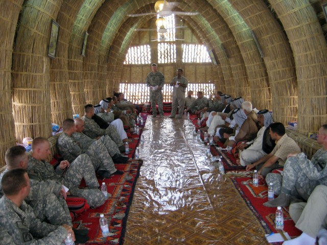 Lt. Col. Scott Kendrick, commander of the Long Knife Brigade's 2-12 Cav. Regt., speaks to leaders in the Muthanna province and his company leaders and staff during a hail-and-farewell for the 4th BCT, 1st Cav. Div., and the outgoing 1st BCT, 82nd...
