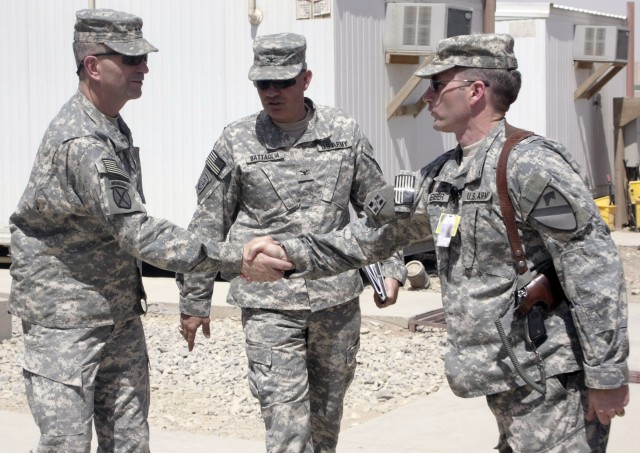 Maj. Gen. Michael Oates, Multi-National Division - Center commander, shakes hands with Lt. Col. Scott Gerber, the Long Knife Brigade's executive officer, while walking with Col. Philip Battaglia, the Long Knife Brigade commander, during a visit at...