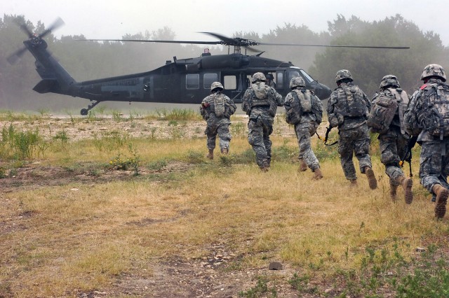 Cavalry scouts from Troop B, 4th Squadron, 9th Cavalry Regiment, 2nd Brigade Combat Team, 1st Cavalry Division, prepare to board a UH-60 Black Hawk helicopter from 3rd Battalion, 227th Aviation Regiment, 1st Air Cavalry Brigade, 1st Cav. Div.,...