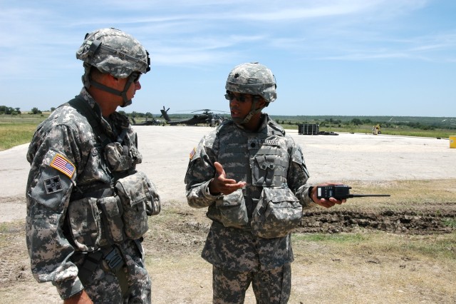 Lieutenant Col. Charles Dalcourt (right), commander of the 1st "Attack" Battalion, 227th Aviation Regiment, 1st Air Cavalry Brigade, 1st Cavalry Division, discusses training operations with Brig. Gen. Frederick Rudesheim, the deputy commanding...