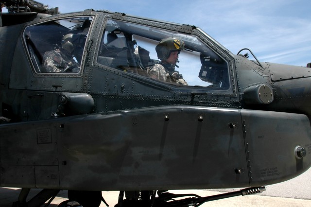 Brigadier Gen. Frederick Rudesheim, the deputy commanding general (Support) for the 1st Cavalry Division, waits in the front seat of an AH-64D Apache attack helicopter piloted by Chief Warrant Officer 4 Frank Almeraz, the standardization...