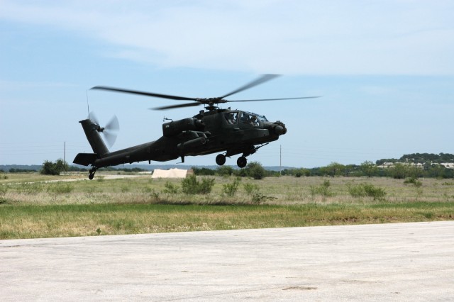 Brigadier Gen. Frederick Rudesheim, the deputy commanding general (Support) for the 1st Cavalry Division, rides in the front seat of an AH-64D Apache attack helicopter piloted by Chief Warrant Officer 4 Frank Almeraz, the standardization...