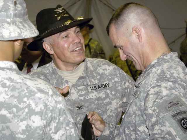 Colonel Philip Battaglia, the commander of the Long Knife Brigade, speaks with Col. Charles Flynn, the commander of the outgoing 1st BCT, 82nd Abn. Div., after a transfer-of-authority ceremony at COB Adder's Memorial Hall July 14. The 4th BCT, 1st...