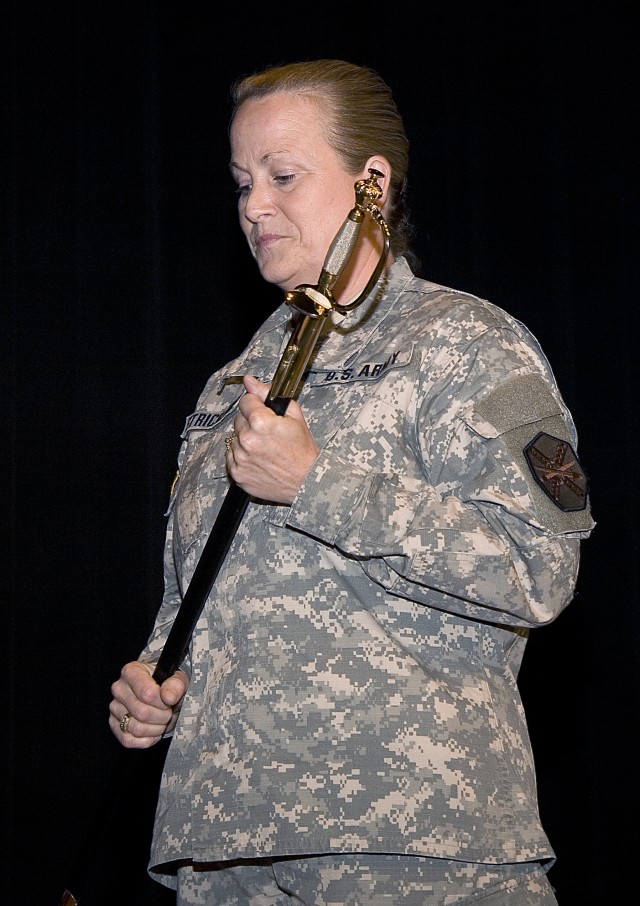 Command Sgt. Maj. Debra L. Strickland prepares to pass the noncommissioned officer sword during a change of responsibility ceremony.
