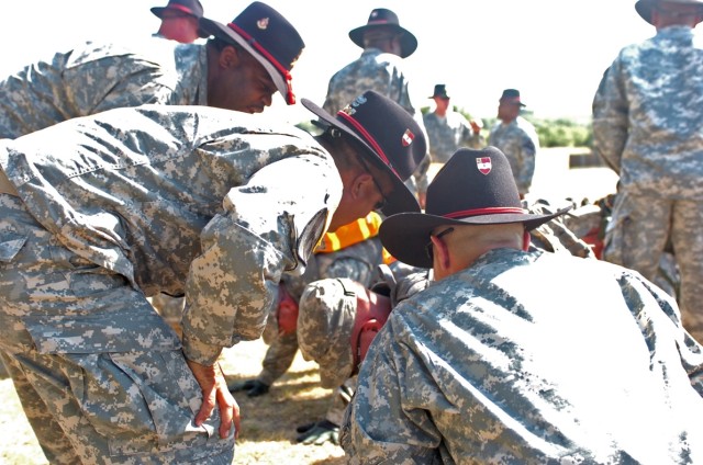 Current Silver Spur holders, with 1st Battalion, 82nd Field Artillery Regiment, 1st Brigade Combat Team, 1st Cavalry Division, urge on a batch of candidates as part of their initiation into the Order of the Silver Spur during the Spur Ride July 17...