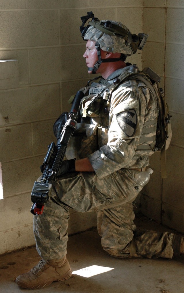 Spc. Allen Laprairie, an infantry Soldier with A Co., 3-8 Cav., 3rd BCT, 1st Cav. Div., from Waniana, Hawii, secures one segment of a room as part of a training exercise on Fort Hood July 17. The brigade conducted a simulation of their upcoming...