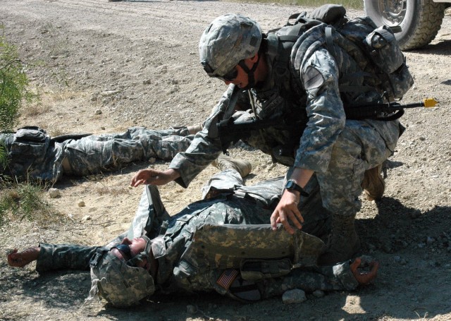 Cpl. Sam Causley, an infantry Soldier with B Company, 3rd Battalion, 8th Cavalry Regiment, 3rd Brigade Combat Team, 1st Cavalry Division, from Monterey, Calif., assesses a simulated casualty who was injured by an Improvised Explosive Device. This tra...