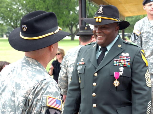 Hunstville, Ala. Native, Command Sergeant Major Stanley D. Small, previous command sergeant major for 1st "Ironhorse" Brigade Combat Team, 1st Cavalry Division receives congratulations from a fellow Soldier after the ceremony.  Small was...