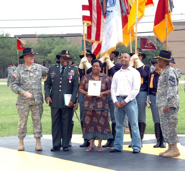 Sioux Falls, S.D. native, Col. Tobin L. Green, commander of 1st Brigade Combat Team awards and congratulates Hunstville, Ala. native, Command Sergeant Major Stanley D. Small, previous Ironhorse command sergeant major on Cooper Field for more than...