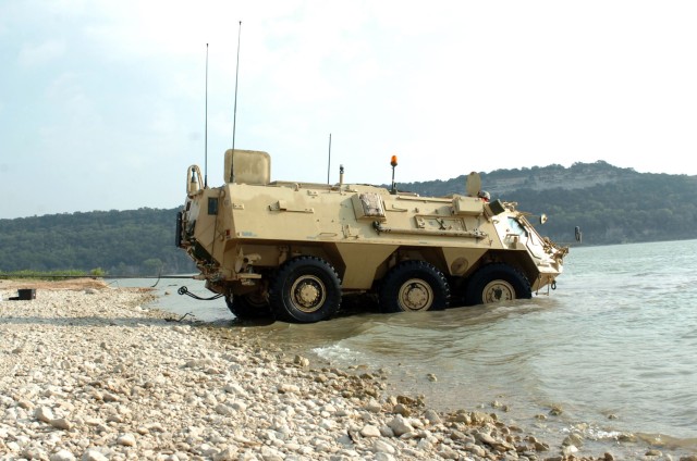 A M93 "Fox" vehicle enters the water for its long journey across Blora Lake, Texas during a training exercise Soldiers from Headquarters and Headquarters Company, 1st Brigade Special Troops Battalion, 1st Brigade Combat Team, 1st Cavalry Division, co...