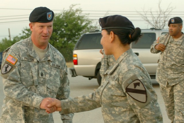 Sgt. Maj. of the Army (SMA) Kenneth O. Preston (left), greets Los Gatos, Calif. native Spc. Diana Bravo, a food service specialist with the 1st Cavalry Division's 15th Brigade Support Battalion, 2nd "Black Jack" Brigade Combat Team at the Horse Caval...