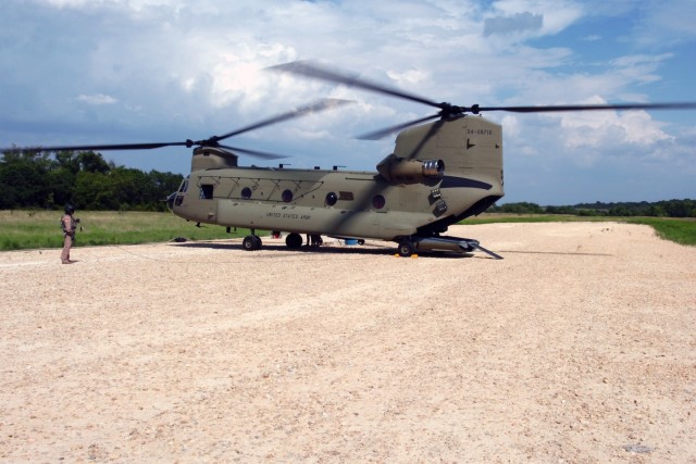 Oxnard, Calif., native Sgt. Miguel-Angel Gonzalez, a flight engineer for Company B, 2nd Battalion, 227th Aviation Regiment, 1st Air Cavalry Brigade, 1st Cavalry Division, waits while the CH-47F Chinook gets refueled at a forward arming and refueling ...