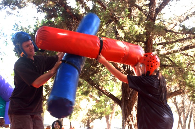 Cameron, Mo. native Sgt. Chris Elman, career counselor, 1st Brigade Combat Team, 1st Cavalry Division, jousts with his daughter, Brittany, during Headquarters and Headquarters Troop, 1st Brigade Combat Team, 1st Cavalry Division, Organizational Day h...