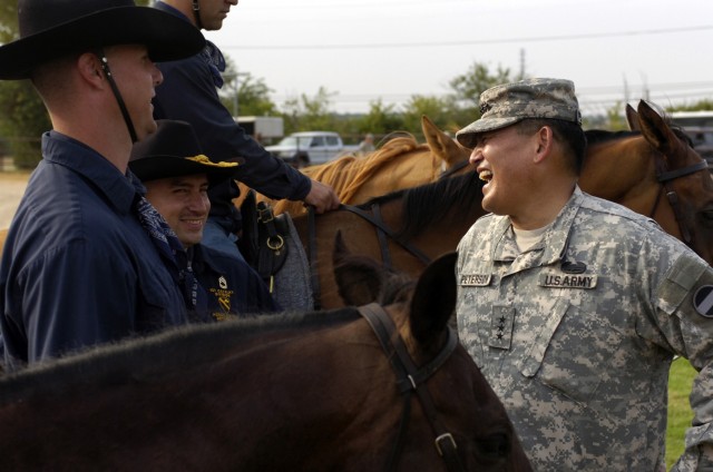 Honolulu, Hawaii native Lt. Gen. Joseph F. Peterson, deputy commanding general/chief of staff, United States Army Forces Command, thanks Soldiers from the 1st Cavalry Division, Horse Cavalry Detachment, at the conclusion of his ride on Fort Hood...