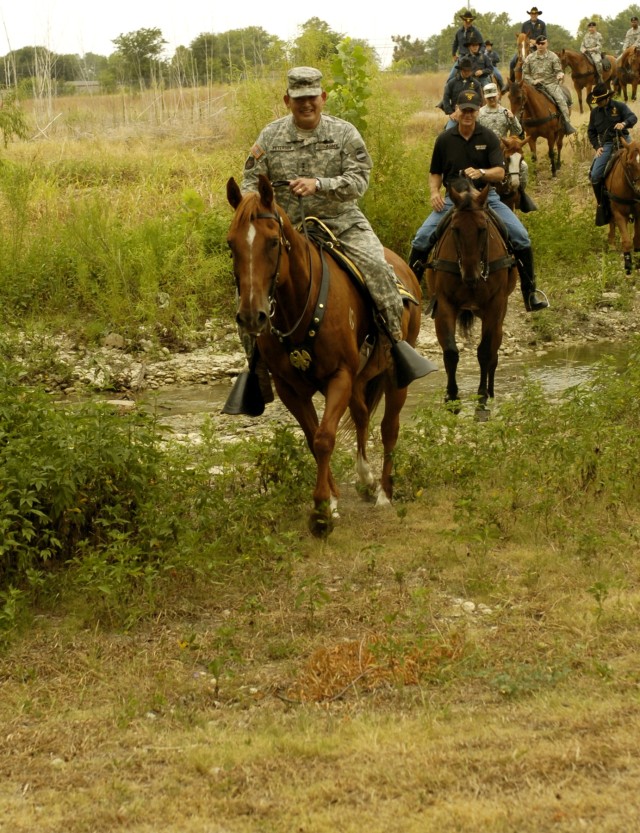 Honolulu, Hawaii native Lt. Gen. Joseph F. Peterson, deputy commanding general/chief of staff, United States Army Forces Command, crosses over a creek bed on horseback during a trail ride at the 1st Cavalry Division's Horse Cavalry Detachment Aug....