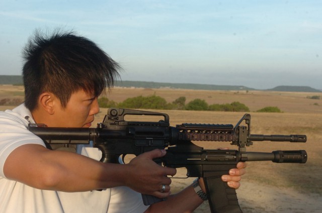 Alan Kong, lead for test and evaluation on the 40M26 Modular Assault Shotgun System, demonstrates the firing technique to the Soldiers of 1st Battalion, 82nd Field Artillery Regiment July 29. Kong, employed with Program Executive Office Soldier, will...
