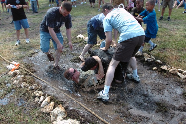 If a lake is too big and scary, use a shallow mud-hole to keep cool during the scorching summer heat. Here Soldiers from the 1st "Attack" Battalion, 227th Aviation Regiment, 1st Air Cavalry Brigade, 1st Cavalry Division, wrestle in the tug-o-war...