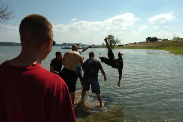 Another way to beat the heat is to exploit a nearby water source - say a lake, for example. Soldiers from the 1st "Attack" Battalion, 227th Aviation Regiment, 1st Air Cavalry Brigade, 1st Cavalry Division, toss a fellow trooper into Belton Lake...