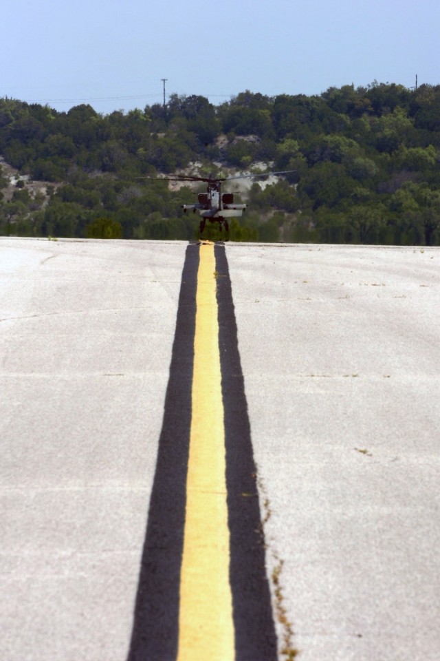 An AH-64D Apache attack helicopter from the 1st "Attack" Battalion, 227th Aviation Regiment, 1st Air Cavalry Brigade, 1st Cavalry Division, hovers at the end of a runway at Robert Gray Army Air Field, Fort Hood, Texas, Aug. 26. Instead of two...