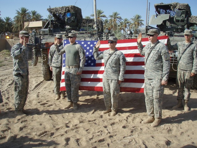 Flag that flew over NYC on 9/11 serves as backdrop for re-enlistments in Iraq