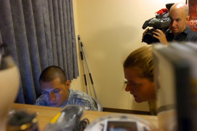 Houston native Pfc. Miguel Noyola, a cannon crewmember with Battery B, 3rd Battalion, 82nd Field Artillery Regiment, 2nd Brigade Combat Team, 1st Cavalry Division, receives direction during filming in his barracks room of a new welcome video to Fort ...