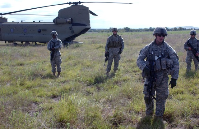 Soldiers from Company D, 2nd "Lancers" Battalion, 5th Cavalry Regiment, 1st "Ironhorse" Brigade Combat Team, 1st Cavalry Division prepare to fly by a CH-47 Chinook helicopter to a drop zone near a high-ranking insurgent to find and interrogate the...