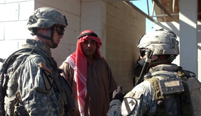Soldiers from Company D "Diablo," 2nd Battalion, 5th Cavalry Regiment, 1st "Ironhorse" Brigade Combat Team, 1st Cavalry Division question a possible Iraqi insurgent as part of an urban terrain missions conducted during Rampage field training Sept....