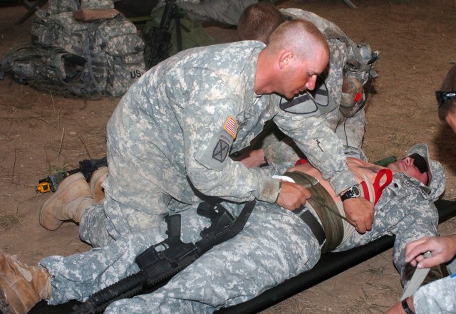 Sgt. Frank Robbins of Eddy, Texas, and an infantryman with Company B, 2nd Battalion, 5th Cavalry Regiment, 1st Brigade Combat Team, 1st Cavalry Division, applies a pressure bandage to a casualty role-player, Spc. William St. Andry assigned to the bat...