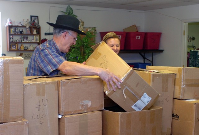 Col. (ret.) Herb Lawson, former commander, Division Support Command, 1st Cavalry Division, shares a laugh Sept. 10 at Fort Hood, Texas with Margret Bond, the Fort Hood thrift shop manager, as they stack boxes containing $32,000 in maternity items whi...