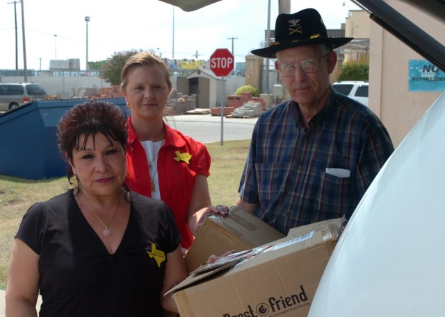 Col. Herb Lawson (ret.), former commander, Division Support Command, 1st Cavalry Division, poses for a photo Sept. 10 at Fort Hood, Texas with Margret Bond (center), manager, Fort Hood thrift shop, and Gloria Ramos (left), the thrift shop's consignme...