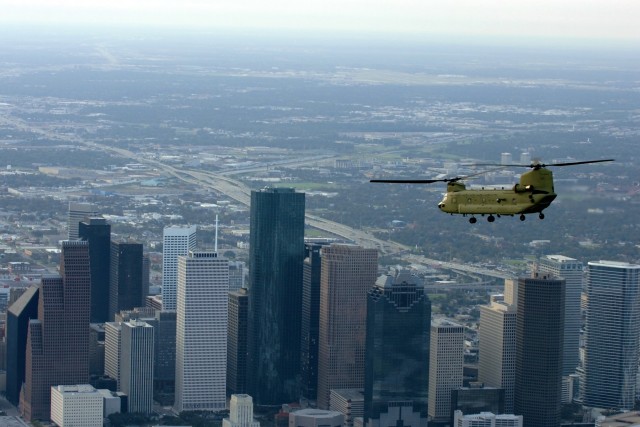 A CH-47 Chinook helicopter from 2nd Battalion, 227th Aviation Regiment, 1st Air Cavalry Brigade, 1st Cavalry Division, flies over Houston on its way to Ellington Field, Texas, for a re-supply mission in support of the Hurricane Ike relief efforts,...