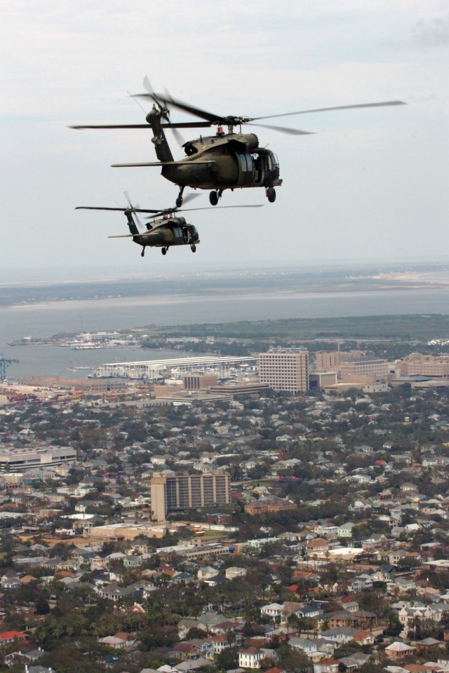 Two UH-60 Black Hawk helicopters from 2nd Battalion, 227th Aviation Regiment, 1st Air Cavalry Brigade, 1st Cavalry Division, fly Gen. Victor Renuart Jr., the commanding general of U.S. Northern Command, and his staff over Galveston, Texas and the...