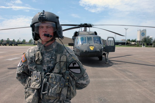 Sgt. Timothy Vasdine, a UH-60 Black Hawk crew chief for Company A, 2nd Battalion, 227th Aviation Regiment, 1st Air Cavalry Brigade, 1st Cavalry Division, stands ready for a mission to fly Gen. Victor Renuart Jr., commanding general of U.S....