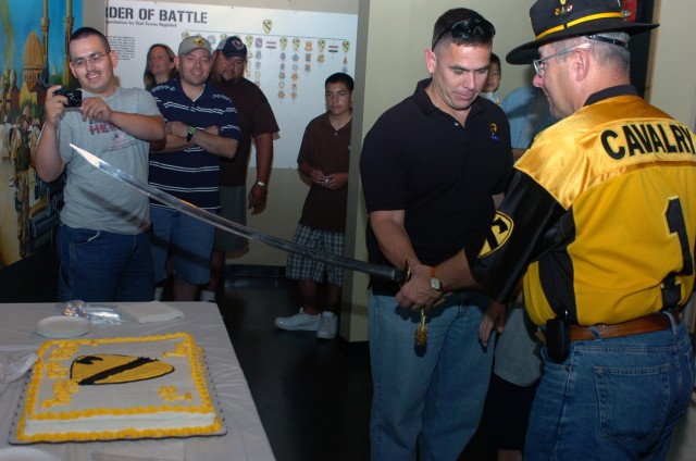 Museum visitors joined in the fun as Command Sgt. Maj. (ret.) Dennis Webster (right), executive director of the 1st Cavalry Division Association, and San Jose, Calif. native Col. Kurt Pinkerton, 1st Cav. Div. operations officer, prepare to cut the...
