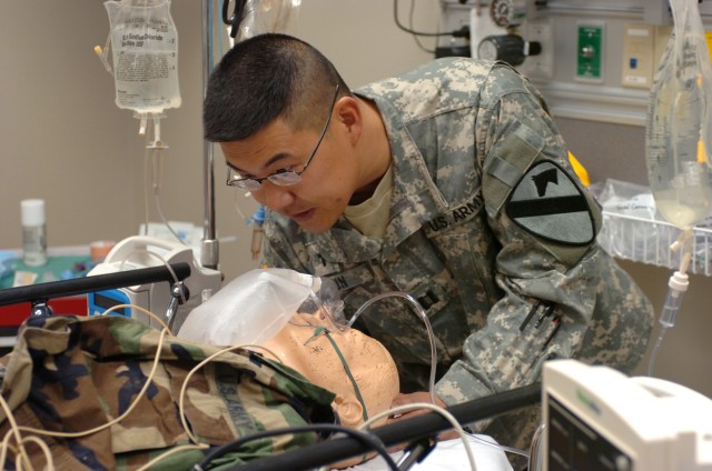 Kentwood, Mich. native, Capt. Jeff S. Pyun, a chaplain with the 1st Battalion, 82nd Field Artillery Regiment, practices his bedside skills on a mannequin at the recreated emergency room during training at Temple College in Temple, Texas Sept. 26. Thi...