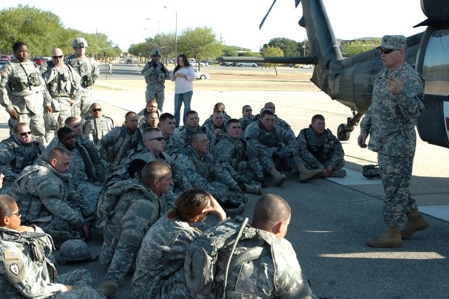 Staff Sgt. Christopher Orange, a flight medic with Company C, 2nd Battalion, 227th Aviation Regiment, talks Soldiers from the 154th Transportation Company, 180th Transportation Battalion, 15th Sustainment Brigade, 13th Sustainment Command...