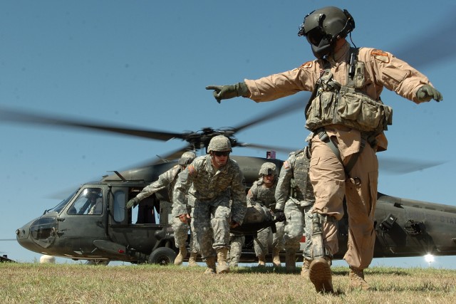 1st Sgt. David Falk, the senior noncommissioned officer and flight medic for Company C, 2nd Battalion, 227th Aviation Regiment, guides Soldiers from the 154th Transportation Company, 180th Transportation Battalion, 15th Sustainment Brigade, 13th...