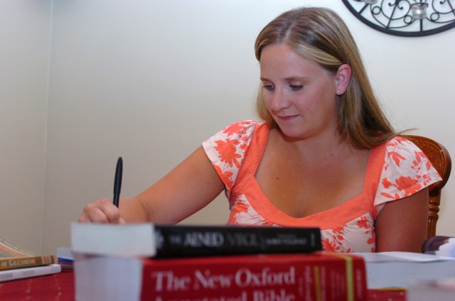 Amid a sea of books, Brandi Waruch, a student at the University of Mary Hardin Baylor and a recipient of a 1st Cavalry Division Association scholarship grant, works on a homework assignment at her house. Waruch, an English major who said she...