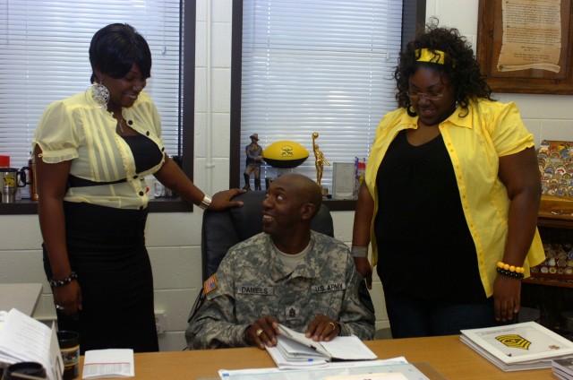 Prior to the beginning of their school day, 1st Cavalry Division Association scholarship recipients, Dameka (right) and Janel Daniels (left) pay an office call on their father, Command Sgt. Maj. James Daniels, the senior-most noncommissioned...