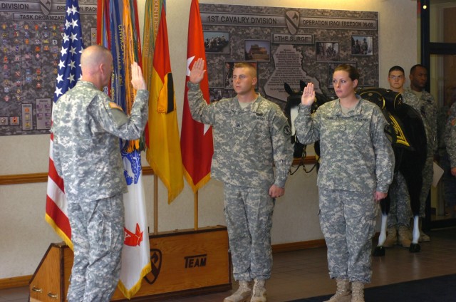 Maj. Gen. Daniel P. Bolger, commanding general, 1st Calvary Division, takes part in reenlisting two Soldiers at Fort Hood, Texas Sept. 22. Winfield, Kan. native, Sgt. Nathan Hayes (center), a military policeman, 64th Military Police Company, 720th...
