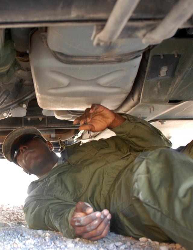 Atlanta Ga. Native Pvt. Daryl Martin, a generator mechanic (32D) with A Company 1st Brigade Support Battalion, 1st Brigade Combat Team, 1st Cavalry Division inspects the under riggings of his gun truck for signs of a leak or rusted conditions to...