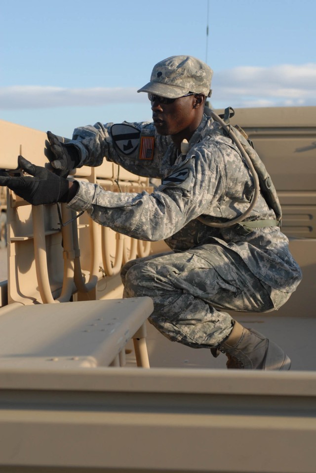 Spc. Mitchell Alphonso Page, Mechanic (63C), Headquarters and Headquarters Company, 115th Brigade Support Battalion, 1st Cavalry Division, who is a native of Portsmouth, Va., Inspects the 'Troop Seats' on an LMTV for serviceability during the 1st...