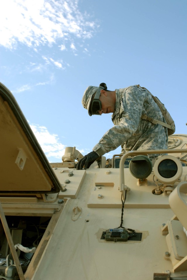 Lincoln Neb. native Spc. Steven L. Blackleter, medic, Headquarters and Headquarters Troop, 1st Squadron, 7th  Cavalry Regiment, 1st Brigade Combat Team, 1st Cavalry Division inspects the drivers hatch on his team's M-113 Track wheeled vehicle...