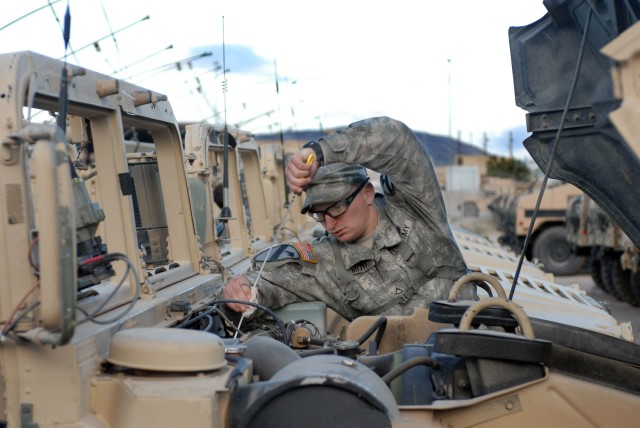 San Diego native Pfc. Jared Smith, forward observer, conducts Preventative Maintenance Checks and Services for his humvee assigned during a vehicle draw Oct. 4 at the National Training Center (NTC) on Fort Irwin, Calif. The checks these...