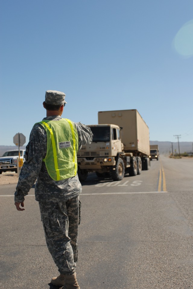 1st Brigade Combat Team, 1st Cavalry Division Safety and Occupational Health Specialist Stephen W. Bell of Nolanville, Texas directs traffic for Soldiers of the 1st Brigade Combat Team, 1st Cavalry Division’s vehicle convoy to the National...