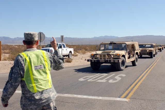 1st Brigade Combat Team, 1st Cavalry Division Safety and Occupational Health Specialist Stephen W. Bell of Nolanville, Texas directs traffic for Soldiers of the 1st Brigade Combat Team, 1st Cavalry Division’s vehicle convoy to the National...