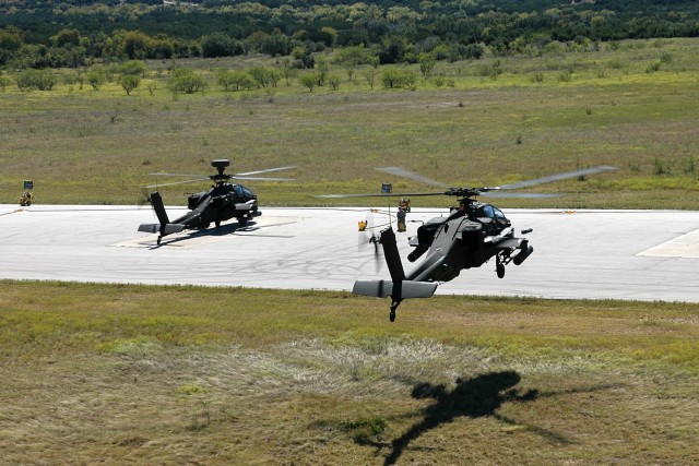 After firing at the range during an aerial gunnery, an AH-64D Apache attack helicopter from the 4th "Guns" Battalion, 227th Aviation Regiment, 1st Air Cavalry Brigade, 1st Cavalry Division, comes in for a landing at a Forward Arming and Refueling...