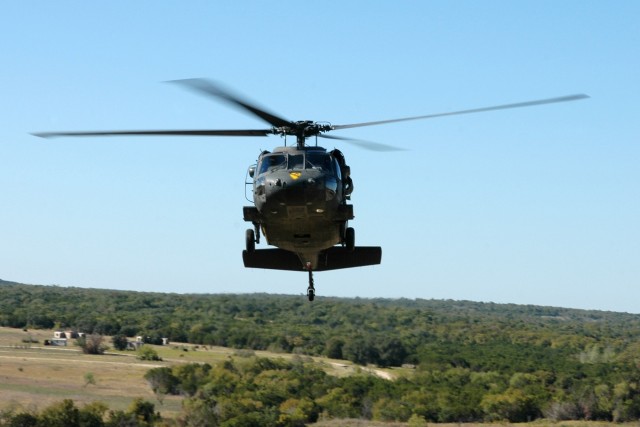 A UH-60 Black Hawk helicopter from the 3rd "Spearhead" Battalion, 227th Aviation Regiment, 1st Air Cavalry Brigade, 1st Cavalry Division, flies over a range at Fort Hood, Texas, during a maneuvers flight Oct. 8. "Spearhead" assault battalion...